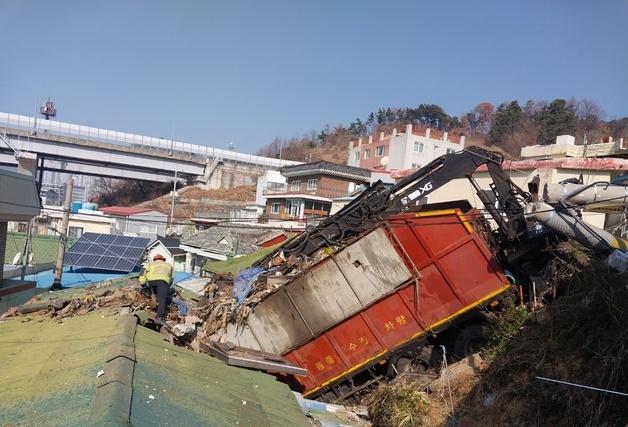 재활용품 수거차량 주택 지붕에 '추락'…내리막길서 도로 이탈 